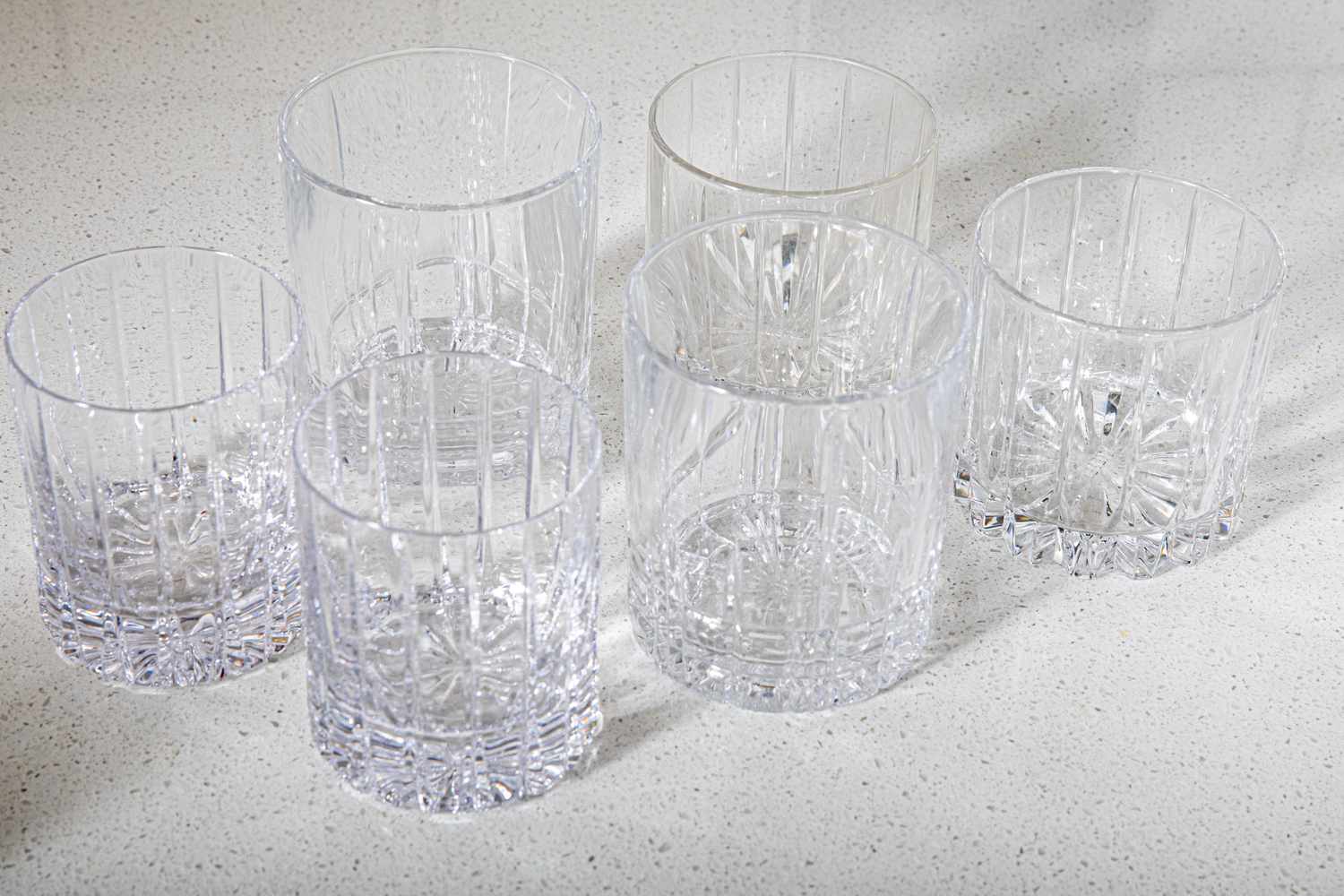 a collection of whiskey glasses on a kitchen countertop