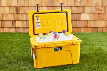 a yellow YETI cooler filled with ice and drinks