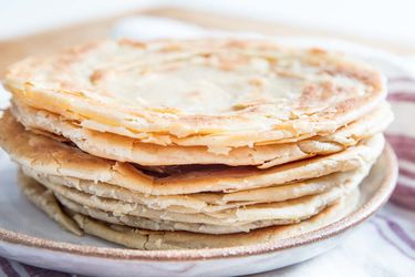 A stack of parathas on a plate.