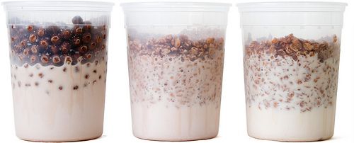 Three quart-size containers with different chocolate cereals in milk