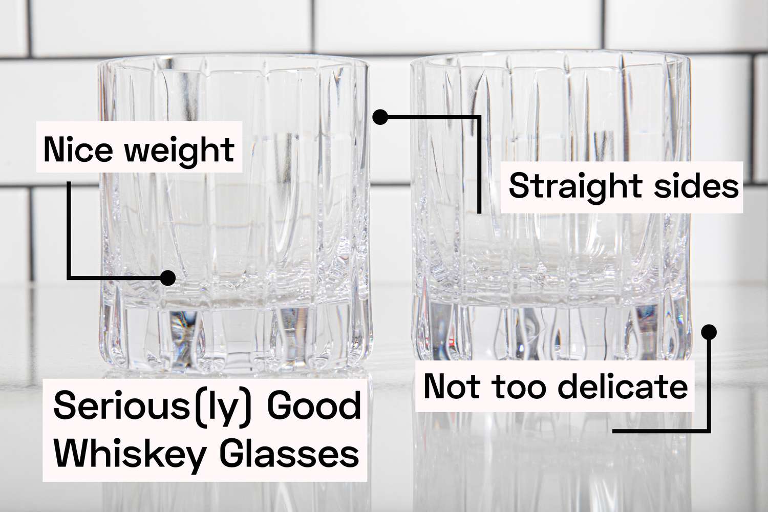 two whiskey glasses on a kitchen countertop