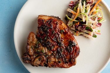 pan seared pork chop with a side salad on a plate