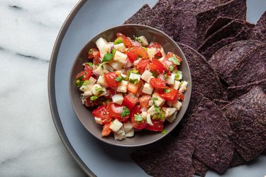 hearts of palm salsa with blue corn chips on a plate