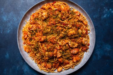The pasta on a large serving platter, sprinkled with parsley-flecked breadcrumbs.