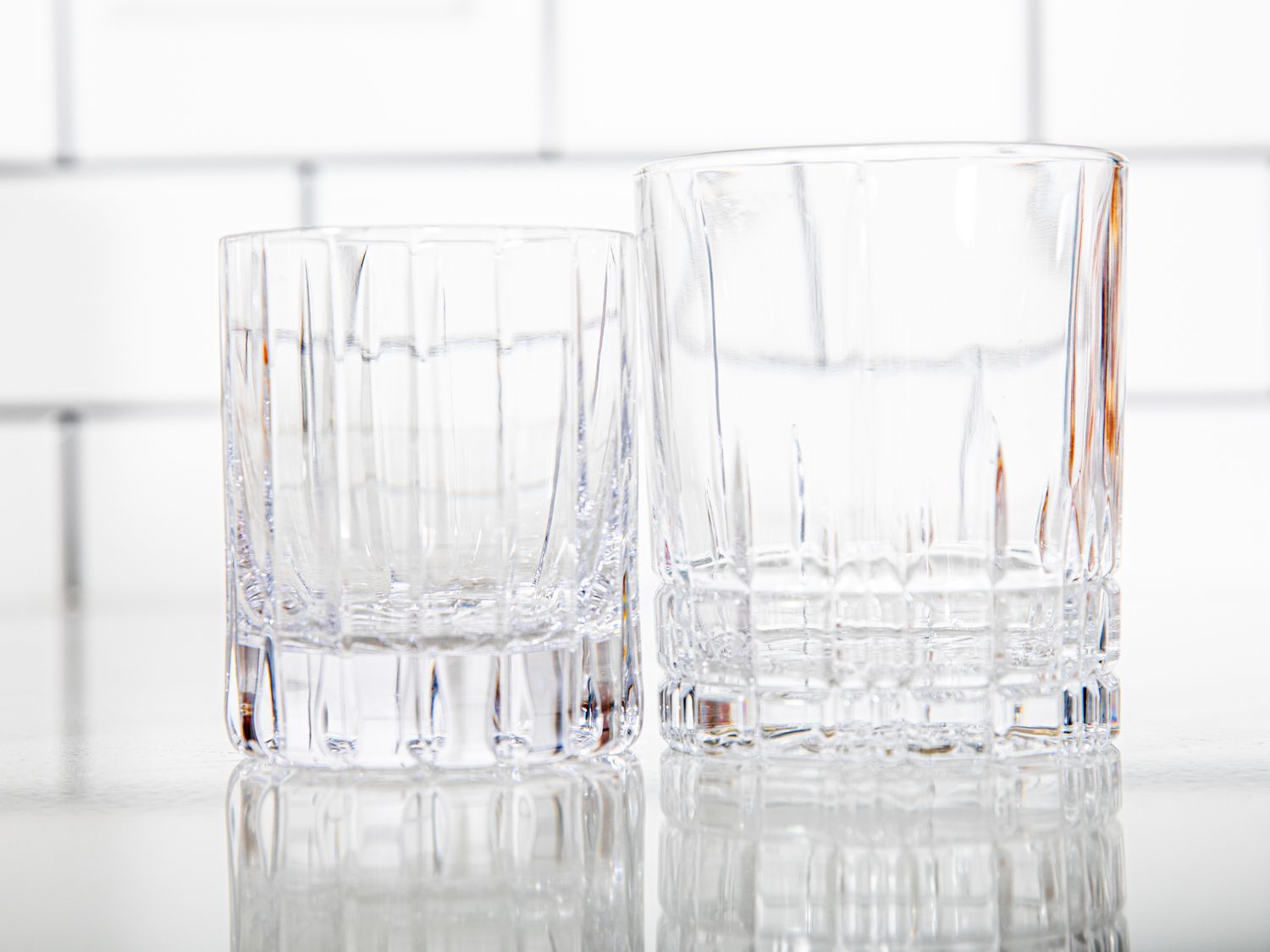 two size rocks glasses beside one another
